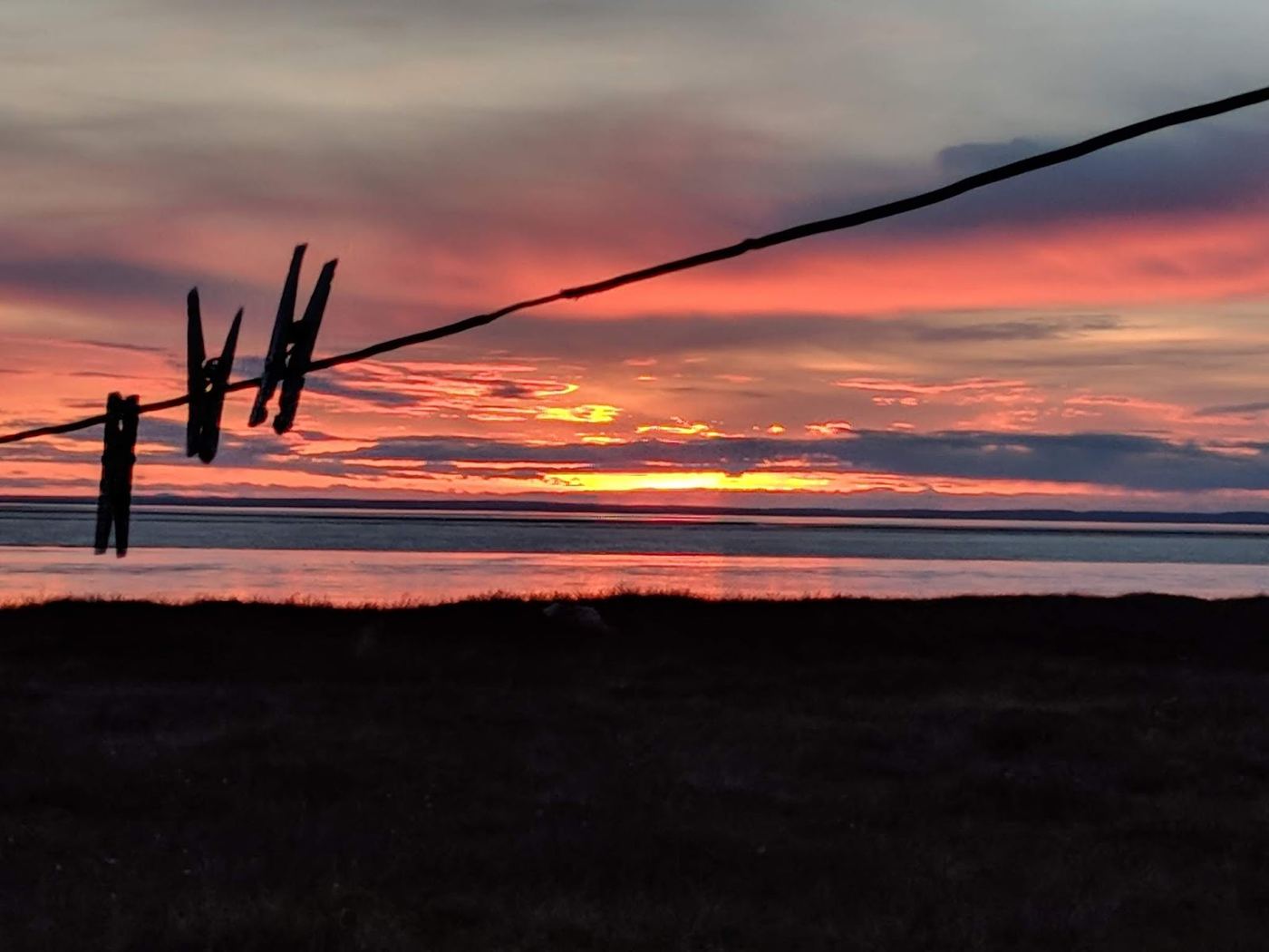 Sunset over Bristol Bay behind a clothesline